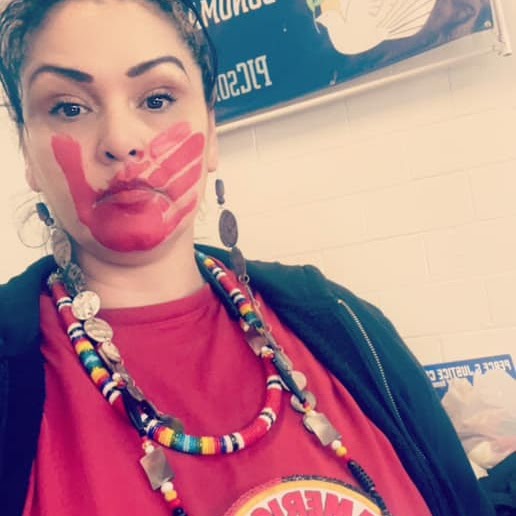 Madonna Festher Cruz with red hand symbol of support for MMIW