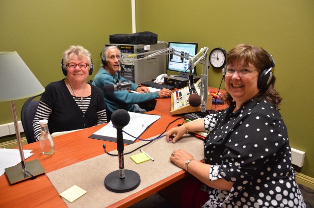 Elaine B. Holtz interviewing Julie Combs with Ken Norton at the sound board for Women's Spaces Radio Show at KBBF studio